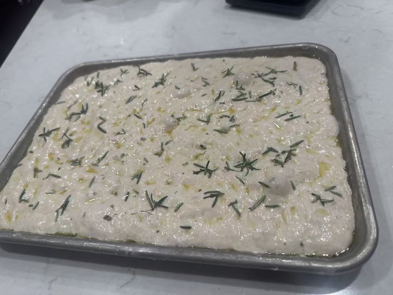 Raw overproofed dough relaxing in the pan